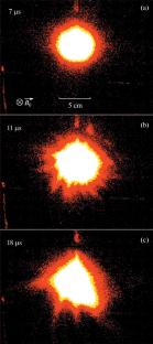 Dynamics of a Plasma Cloud Generated by a Compact Coaxial Gun upon Expansion into Vacuum and Large-Volume Background Plasma in an External Magnetic Field