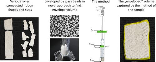 Method to determine envelope density for roller compacted ribbons by solid displacement of glass microspheres