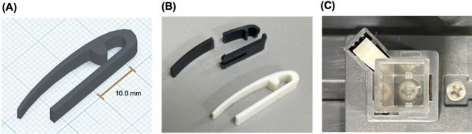 3D-printed cuvette holder clip for a spectrophotometer.